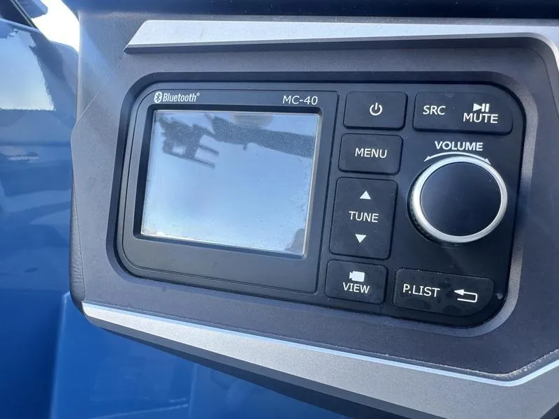 Slide: The Image of Close-up of a 2022 Axis A24 boat control panel with Bluetooth and volume controls. - 15