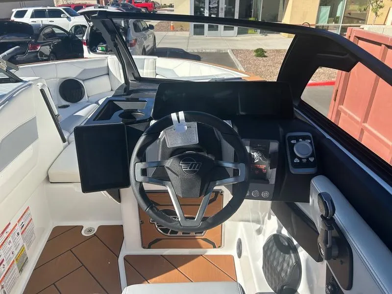Slide: The Image of 2025 Malibu 23 LSV boat cockpit with modern steering and controls. - 12