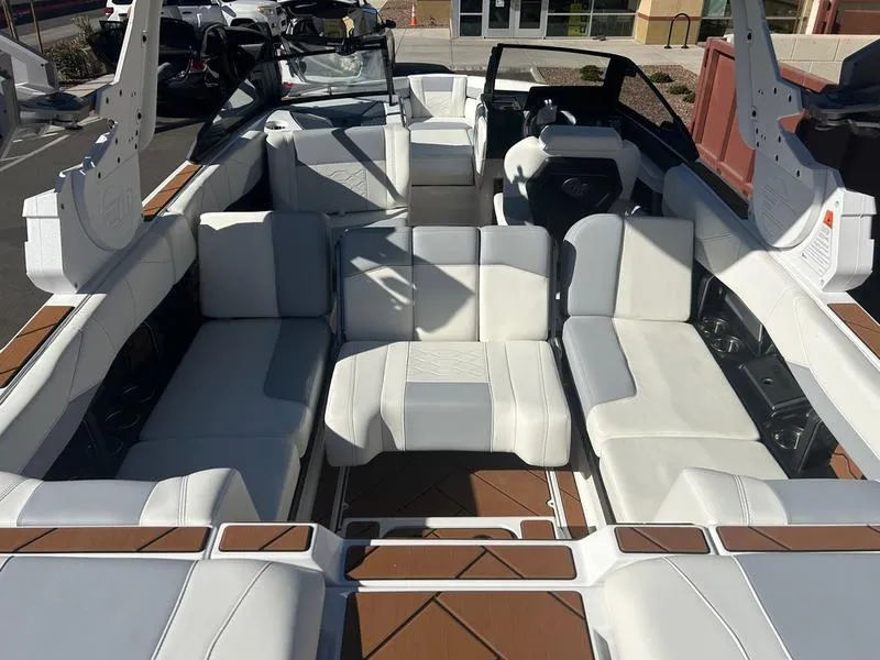 Slide: The Image of 2025 Malibu 23 LSV boat interior with spacious white seating and modern design. - 17