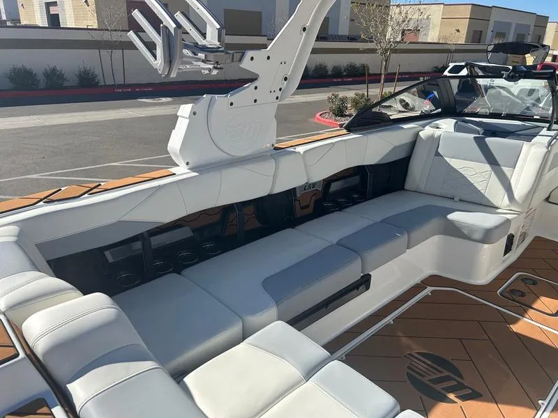 Slide: The Image of 2025 Malibu 23 LSV boat interior with sleek seating and modern design. - 18