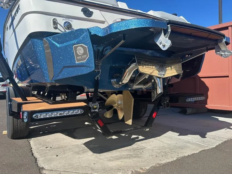 Slide: The Image of 2025 Malibu 23 LSV boat rear view, showcasing propeller and hull design. - 7