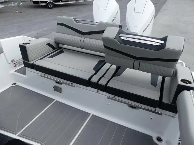 Slide: The Image of 2025 Monterey Elite 30 OB boat with sleek gray seating and dual outboard engines. - 12