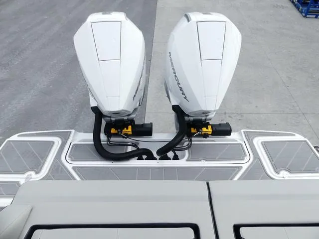 Slide: The Image of 2025 Monterey Elite 30 OB boat with dual Mercury outboard engines, rear view. - 13
