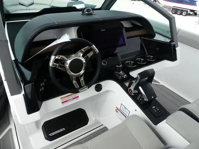 Slide: The Image of Cockpit of 2025 Monterey Elite 30 OB boat with modern steering and controls. - 18