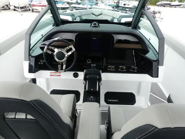 Slide: The Image of 2025 Monterey Elite 30 OB boat interior with modern dashboard and steering wheel. - 19