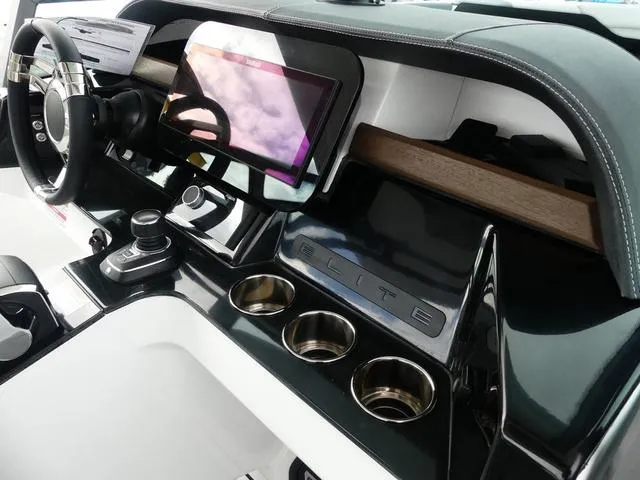 Slide: The Image of 2025 Monterey Elite 30 OB dashboard with touchscreen, steering wheel, and cup holders. - 21