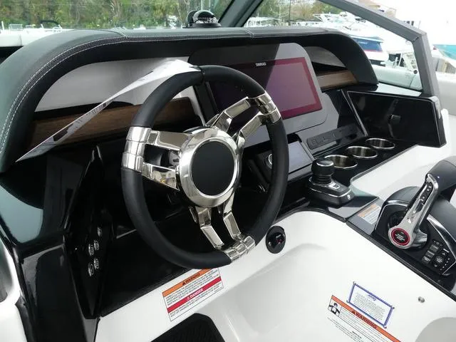 Slide: The Image of 2025 Monterey Elite 30 OB boat dashboard with modern steering wheel and control panel. - 22