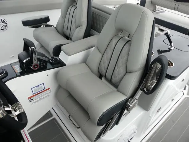 Slide: The Image of Luxury seating in 2025 Monterey Elite 30 OB boat cockpit, featuring modern controls and design. - 23