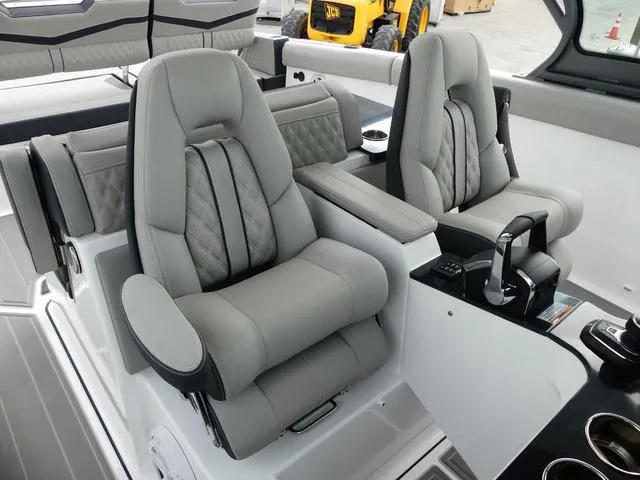 Slide: The Image of 2025 Monterey Elite 30 OB boat interior with luxurious gray seating and modern controls. - 24