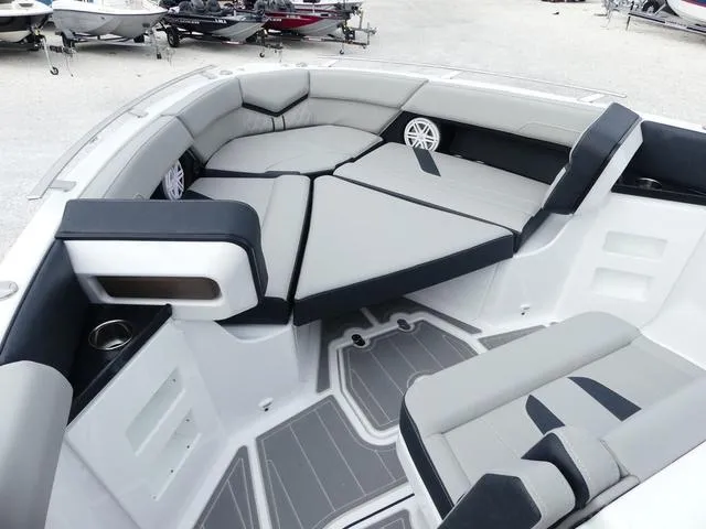 Slide: The Image of Luxurious seating area on 2025 Monterey Elite 30 OB boat, featuring modern design and comfortable cushions. - 26