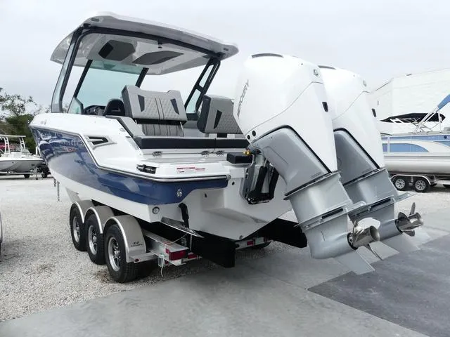 Slide: The Image of 2025 Monterey Elite 30 OB boat with dual outboard engines on a trailer. - 5