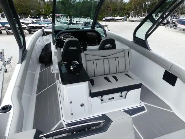 Slide: The Image of 2025 Monterey Elite 30 OB boat interior with modern seating and dashboard. - 9