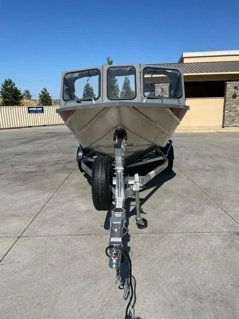 Slide: The Image of 2025 Spartan 185 Astoria boat on trailer, parked outdoors on concrete surface. - 10