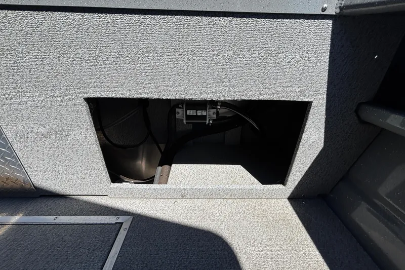 Slide: The Image of Open compartment in 2025 Spartan 185 Astoria boat, showing interior wiring and components. - 23