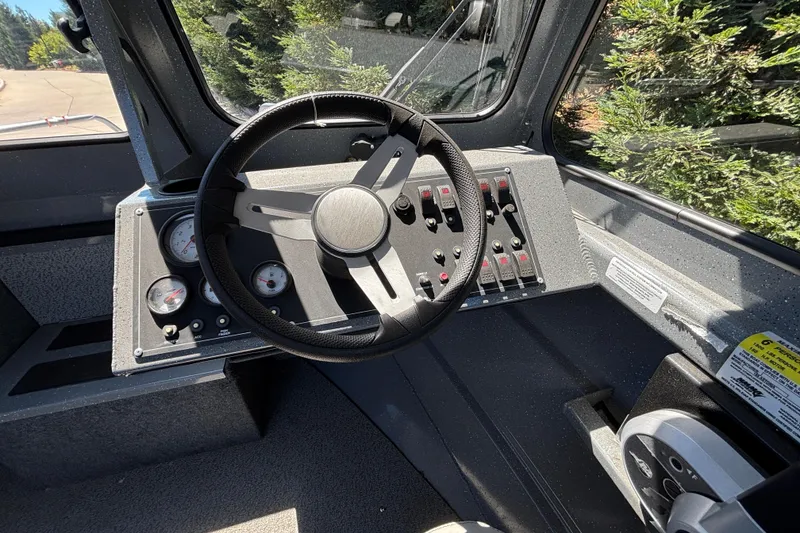 Slide: The Image of Steering console of 2025 Spartan 185 Astoria boat with gauges and controls. - 17