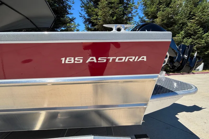 Slide: The Image of 2025 Spartan 185 Astoria boat with red and silver exterior, parked outdoors. - 8