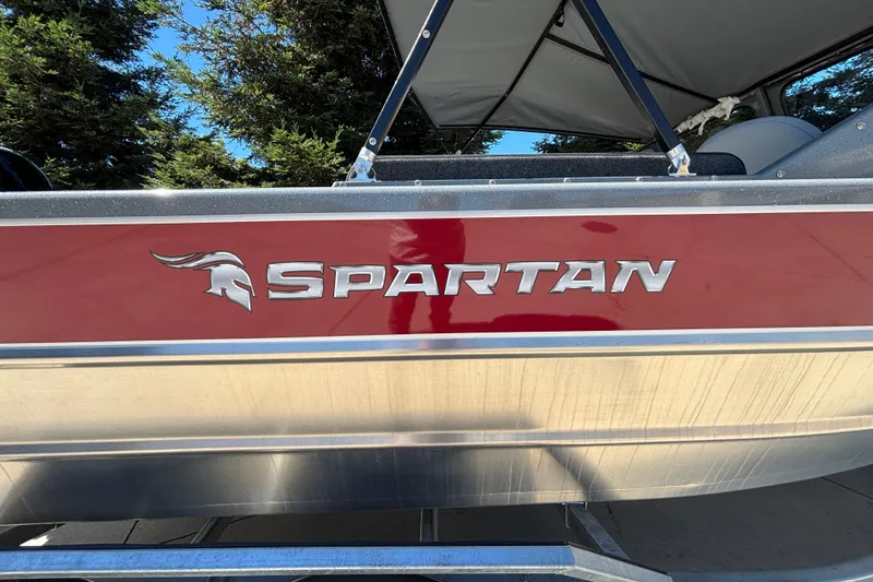 Slide: The Image of 2025 Spartan 185 Astoria boat with red and silver detailing, parked outdoors. - 7