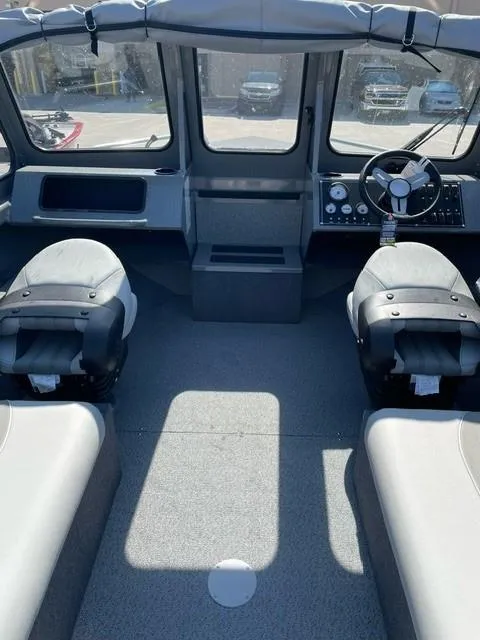 Slide: The Image of Interior of 2025 Spartan 185 Astoria boat with modern seating and dashboard. - 4