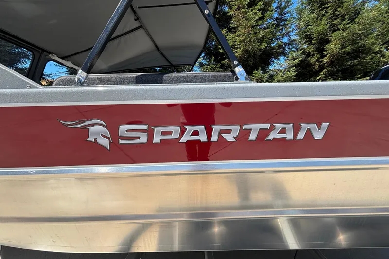 Slide: The Image of 2025 Spartan 185 Astoria boat with red and silver detailing, featuring bold logo. - 9