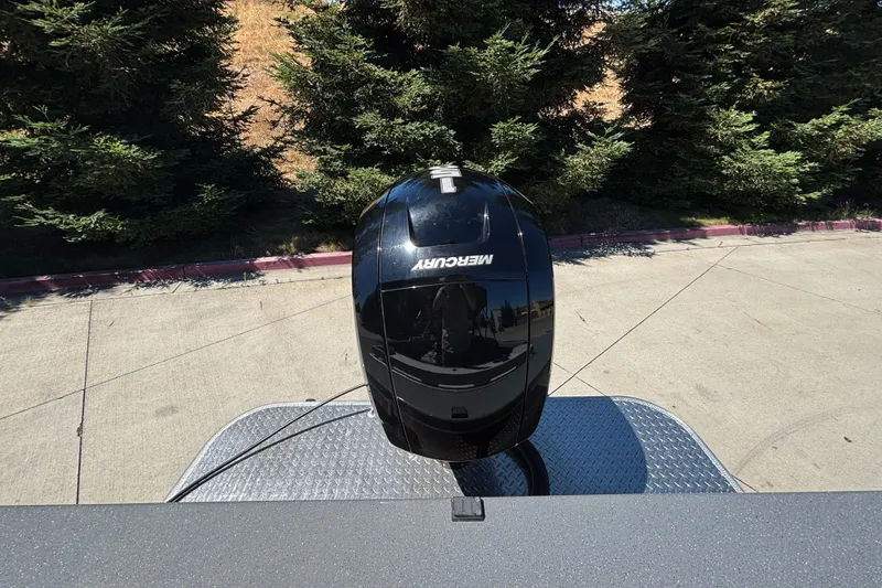 Slide: The Image of Top view of a 2025 Spartan 185 Astoria with a Mercury engine, surrounded by trees. - 26