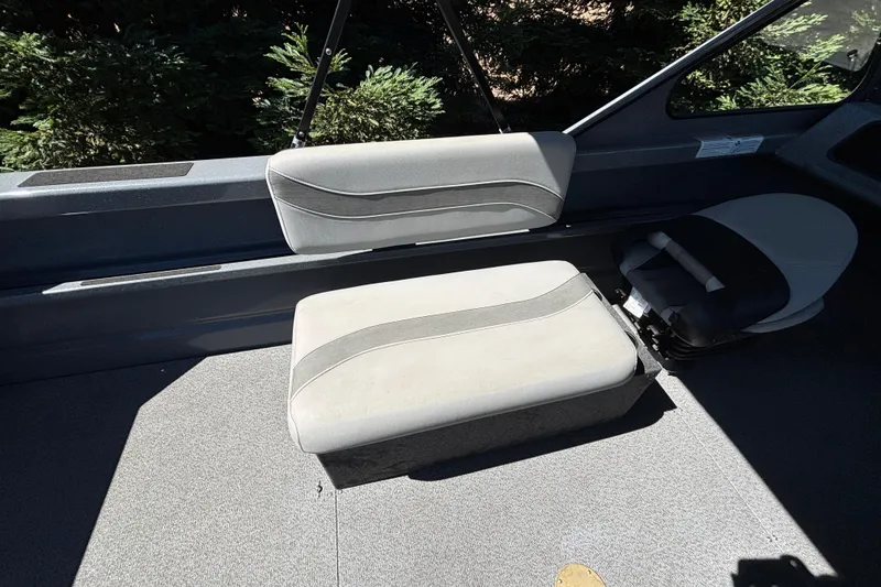 Slide: The Image of Interior seating of 2025 Spartan 185 Astoria boat, featuring gray cushioned seats. - 31