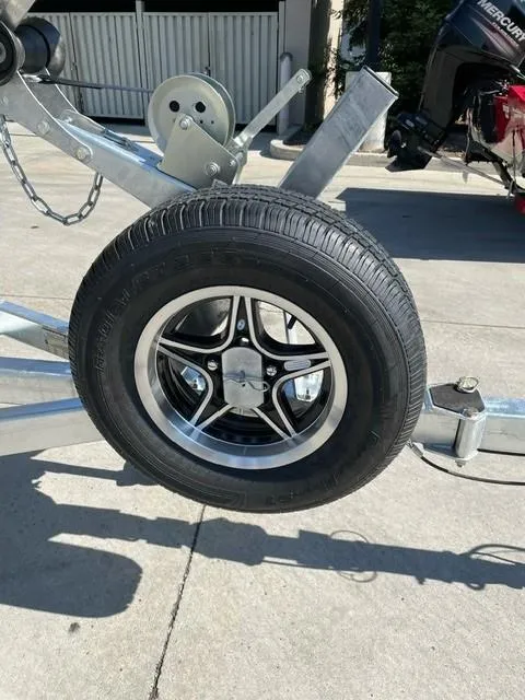 Slide: The Image of Trailer wheel of 2025 Spartan 185 Astoria, featuring sleek black and silver design. - 9