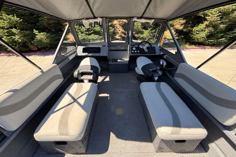 Slide: The Image of Interior of 2025 Spartan 185 Astoria boat with seating and steering console. - 15