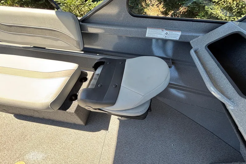 Slide: The Image of Interior seating of 2025 Spartan 185 Astoria boat, featuring gray cushioned seats. - 27