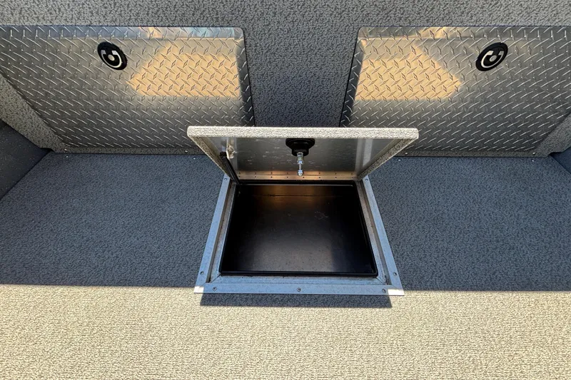 Slide: The Image of Open storage compartment in 2025 Spartan 185 Astoria boat with diamond plate covers. - 22