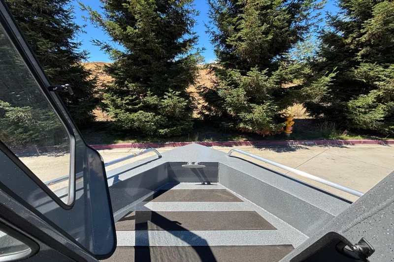 Slide: The Image of 2025 Spartan 185 Astoria boat interior with trees in the background. - 13