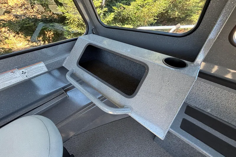 Slide: The Image of Interior of 2025 Spartan 185 Astoria boat with storage compartment and cup holder. - 30