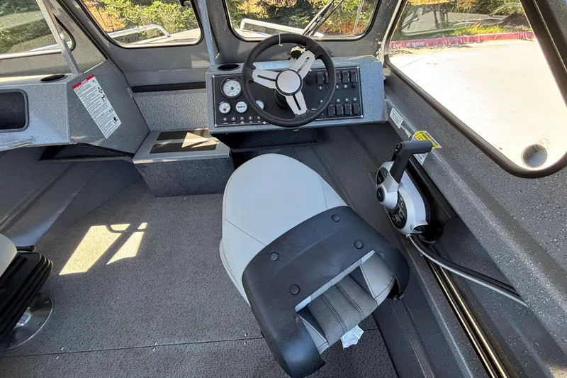 Slide: The Image of Interior of 2025 Spartan 185 Astoria boat with steering wheel and control panel. - 38