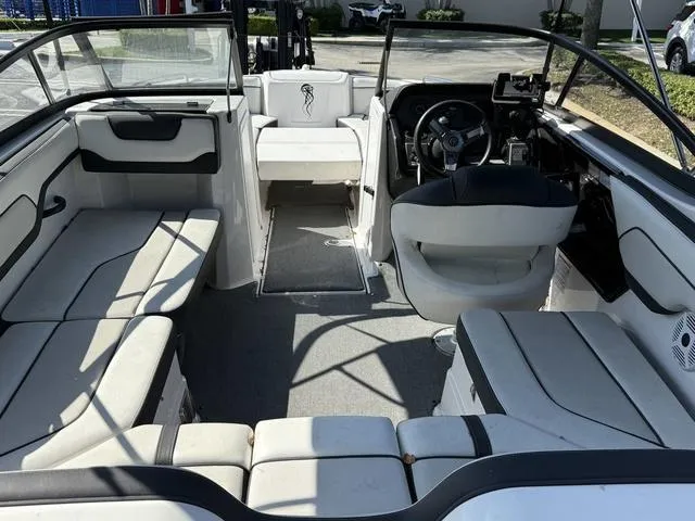 Slide: The Image of 2018 Yamaha Boats SX210 interior with spacious seating and modern dashboard. - 12