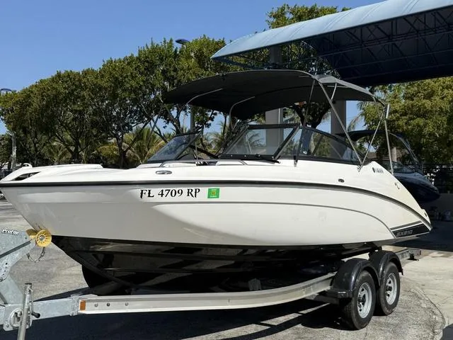 Slide: The Image of 2018 Yamaha Boats SX210 on trailer, parked outdoors under a canopy. - 13