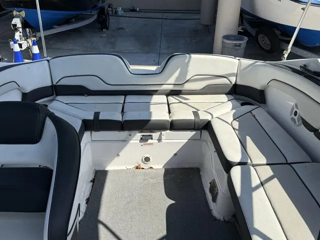 Slide: The Image of 2018 Yamaha SX210 boat on trailer in parking lot, overcast sky. - 8