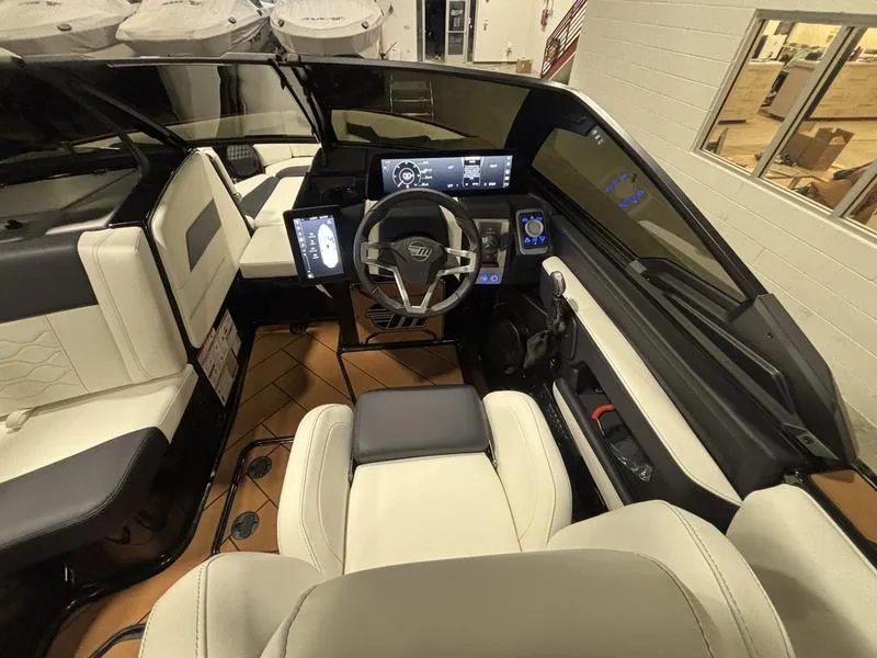 Slide: The Image of 2025 Malibu 23 LSV boat interior with modern dashboard and luxurious seating. - 15
