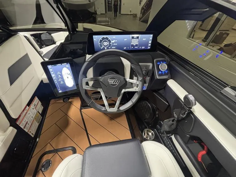 Slide: The Image of 2025 Malibu 23 LSV boat cockpit with modern steering and digital displays. - 16