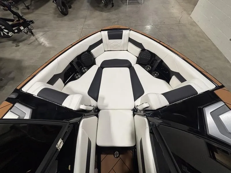 Slide: The Image of 2025 Malibu 23 LSV boat interior with luxurious white and black seating. - 22
