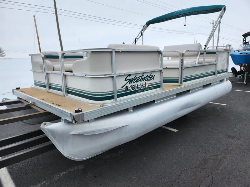 Slide: The Image of 2000 Sweetwater 180 pontoon boat with canopy, parked on a trailer. - 5