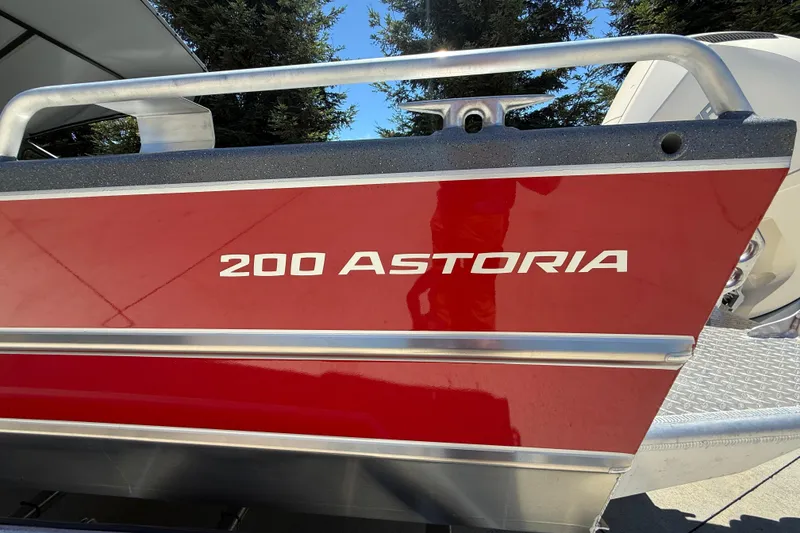 Slide: The Image of Red 2025 Spartan 200 Astoria boat with sleek design and metallic accents. - 14