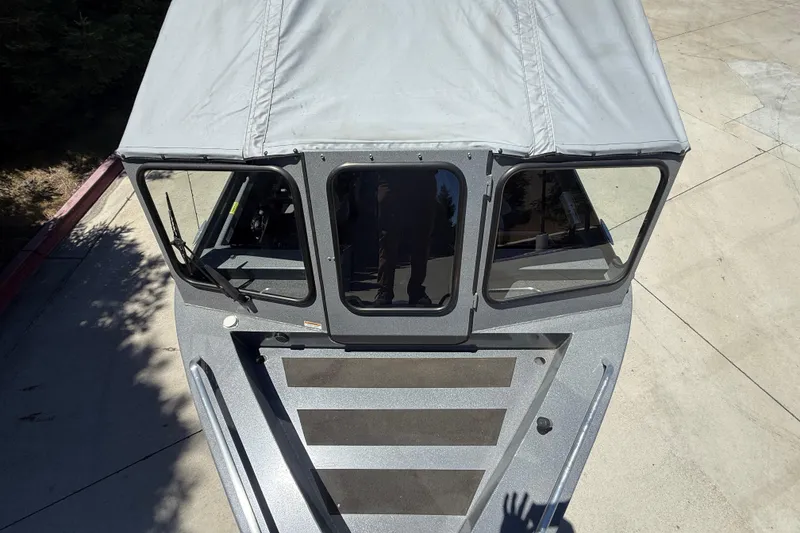 Slide: The Image of Overhead view of 2025 Spartan 200 Astoria boat with canopy and windshield. - 10