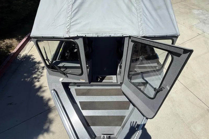 Slide: The Image of 2025 Spartan 200 Astoria boat with open cabin doors, viewed from above. - 11