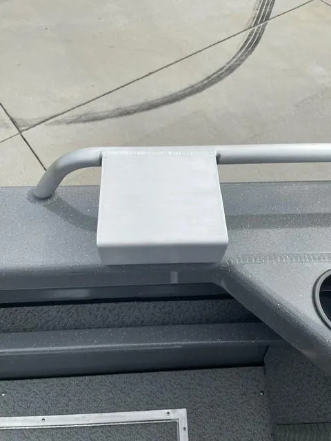 Slide: The Image of 2025 Spartan 200 Astoria boat detail, featuring a sleek gray surface and railing. - 4