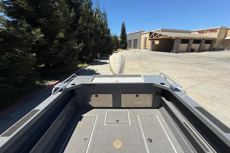 Slide: The Image of 2025 Spartan 200 Astoria boat interior, featuring spacious deck and storage compartments. - 28