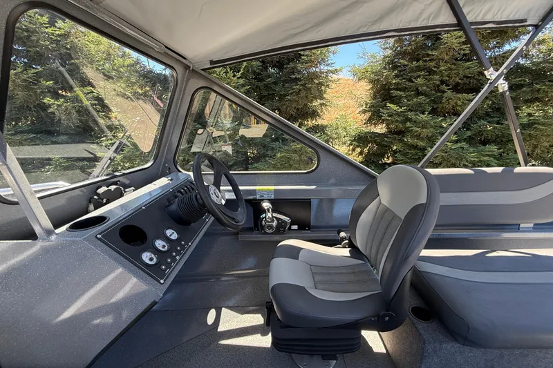Slide: The Image of Interior of 2025 Spartan 200 Astoria boat with modern steering and seating. - 23