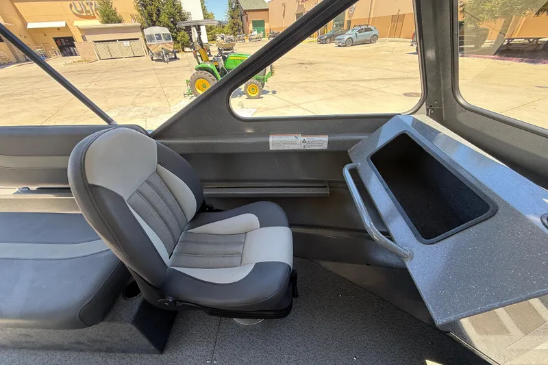 Slide: The Image of Interior of 2025 Spartan 200 Astoria boat with gray seating and dashboard. - 26