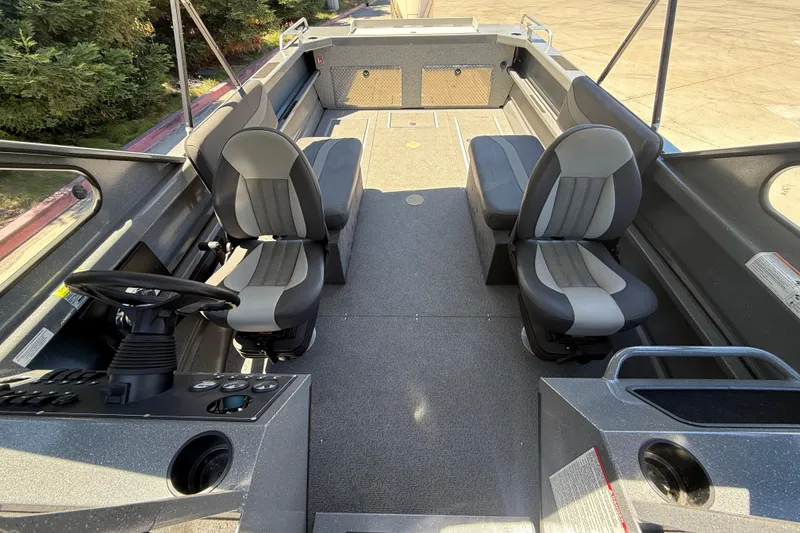 Slide: The Image of Interior of 2025 Spartan 200 Astoria boat with modern seating and steering console. - 21