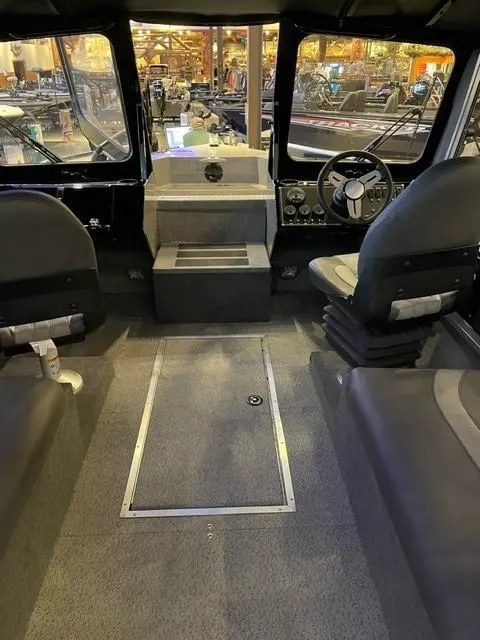 Slide: The Image of Interior of 2023 Spartan 215 Athens boat, featuring seating and steering wheel. - 14