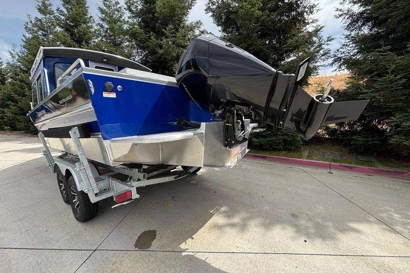 Slide: The Image of 2025 Spartan 240 Maximus Pro boat on trailer, featuring sleek design and powerful outboard motor. - 6