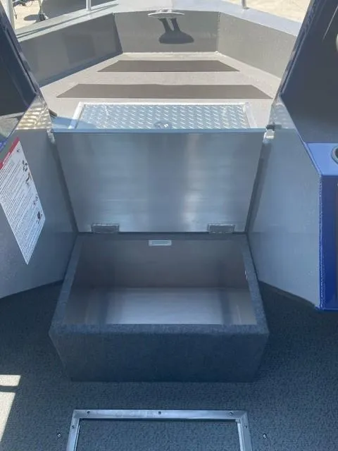 Slide: The Image of 2025 Spartan 240 Maximus Pro boat storage compartment, open and empty. - 11